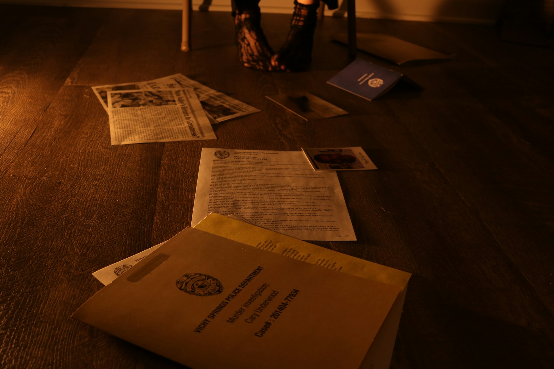 A insurance policy envelope, and documents on a wooden floor