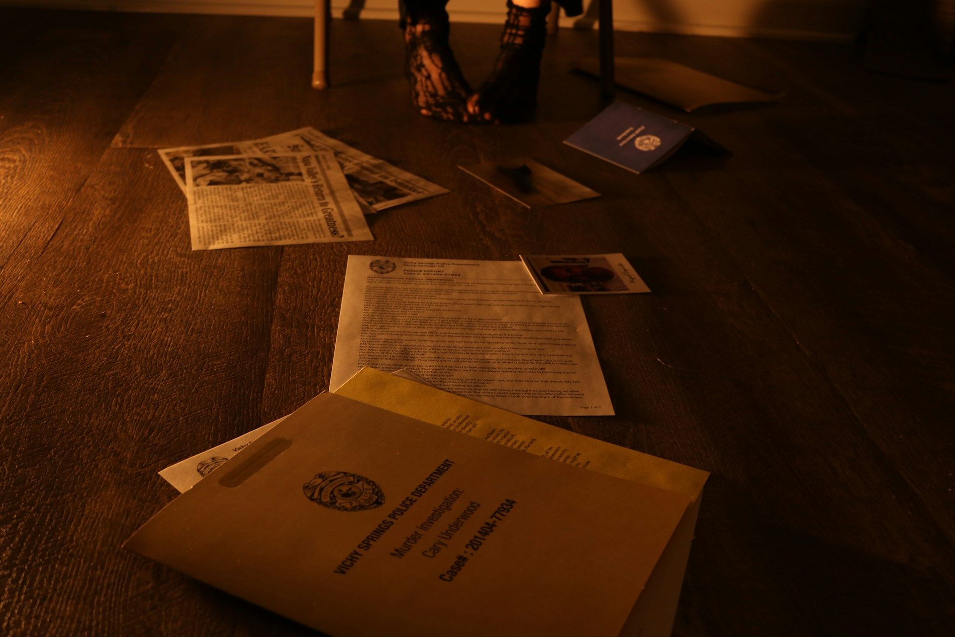 A insurance policy envelope, and documents on a wooden floor