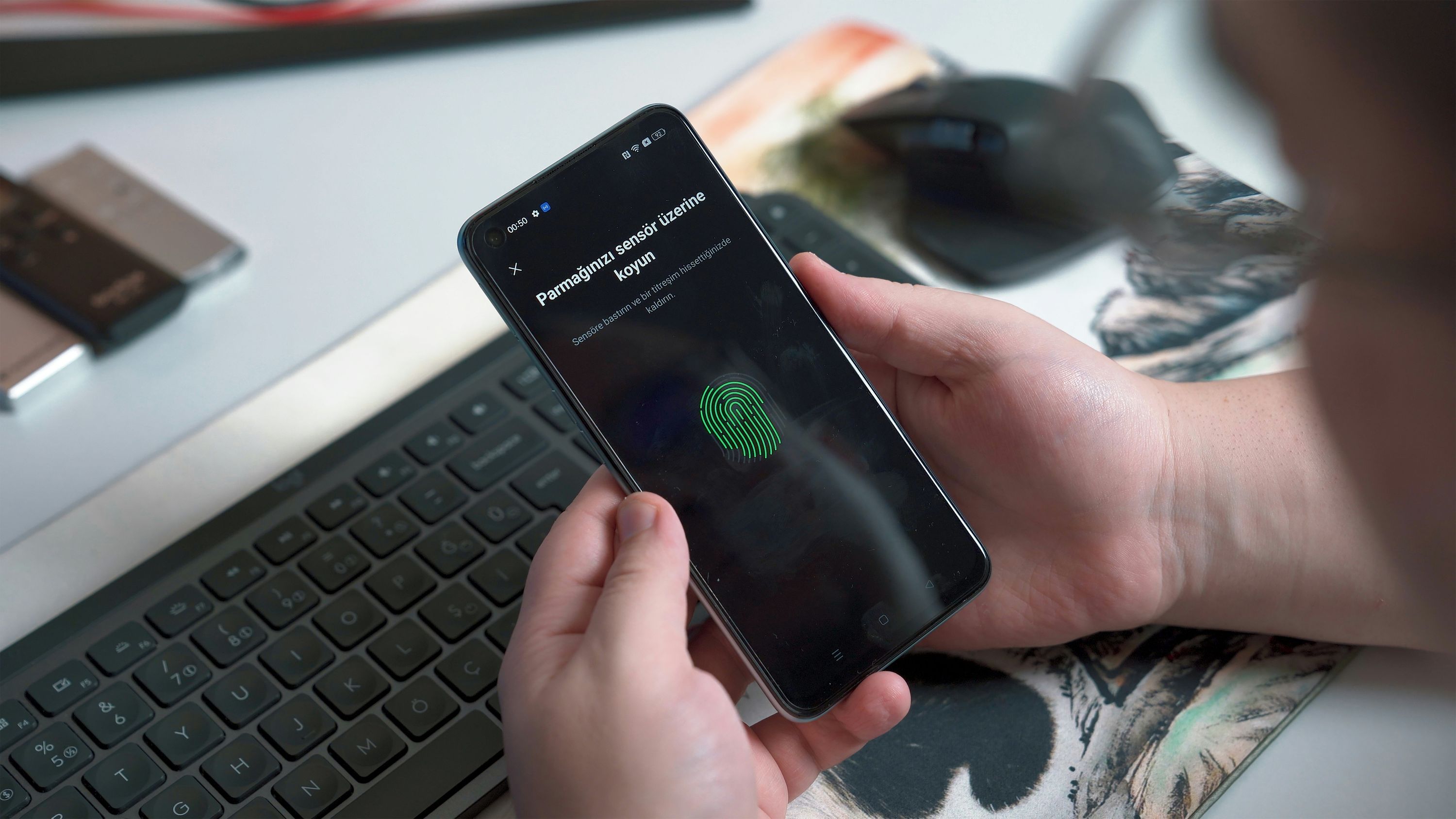 smartphone with a biometric unlock indicator glowing.